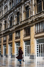 young woman dance in galleria umberto, back view, naples, italy