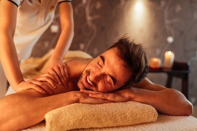 young man enjoying a massage at a spa
