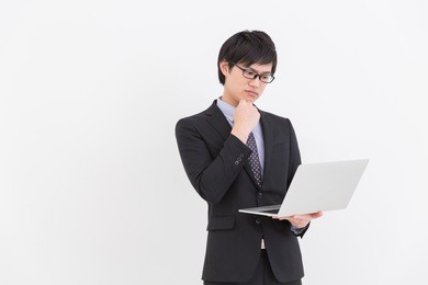 asian businessman who uses  laptop computer,think,