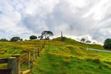 landscape view of one tree hill park auckland new zealand; calm morning time with a cloudy period