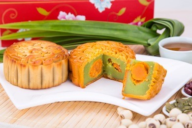close-up on sliced mooncake with egg yoke, pastries for chinese mid-autumn festive celebration