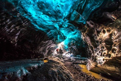 ice cave in vatnajokull, iceland.the beauty of the caves filled with blue ice.