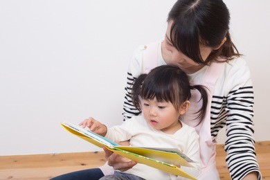 asian nurse playing with toddler