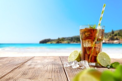 summer drink on wooden table and beach landscape. 