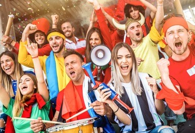football supporter fans friends cheering and watching soccer cup match at intenational stadium - young people group with multicolored t-shirts having excited fun on sport world championship concept
