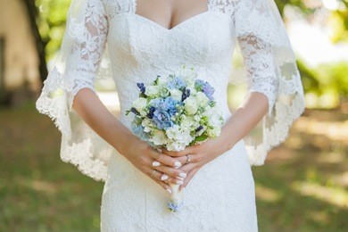 the bride in a white dress is holding a bouquet of flowers. wedding concept