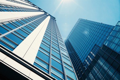 up to see modern skyscrapers in the city with beautiful sky and sunshine.       