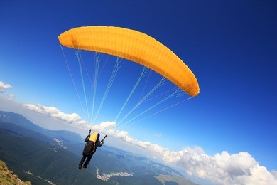 paraglider taking off from a mountain