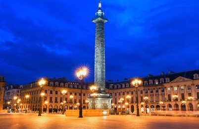 vendome column with statue of napoleon bonaparte, on the place vendome at night, in france. vendome column has 425 spiraling bas-relief bronze plates were made out of cannon.