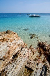 boat floating on the sea water at kapas island tropical beach malaysia