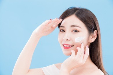 woman with sun protection concept on the blue backgorund