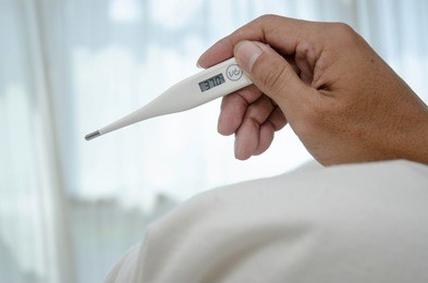 asian man sick.monitor body temperature with mercury.thermometer in asian male hands.