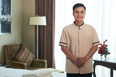 smiling vietnamese porter in hotel room