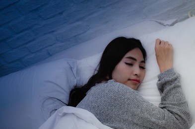 on the bed in the white room.