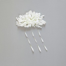 spring or summer minimalist concept. cloud with raindrops made of white petals on gray paper background. flat lay, top view.