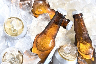 beer bottle and can chilled in ice