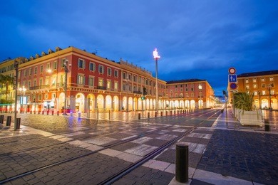 night cityscape  on massena square in downtown near famous promenade des anglais. it is main city square decorated with stylish streetlights. nice, france. french riviera (cote d'azur)