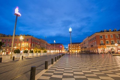 night cityscape  on massena square in downtown near famous promenade des anglais. it is main city square decorated with stylish streetlights. nice, france. french riviera (cote d'azur)