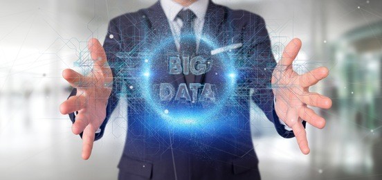 view of a particles big data title holding by a businessman