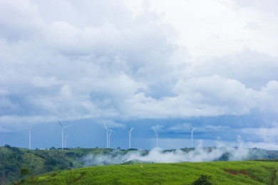 mountain  blue sky white clouds fog wind turbine field green rice in the valley background empty space