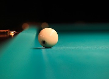 playing billiard. billiards balls and cue on green billiards table. russian pyramid.