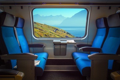 panoramic view of geneva lake and the vineyard of lavaux close to lausanne, switzerland viewed from the train window. lighting effect on the window.