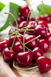 fresh cherries on wooden board