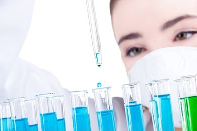 female researcher with test tubes in laboratory