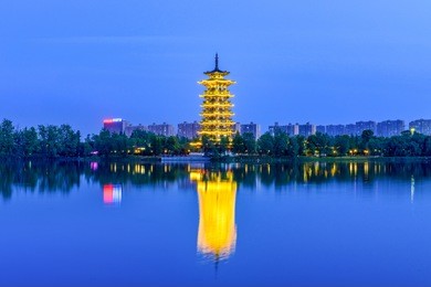 the night view of the pagoda of changsha ocean lake wetland park