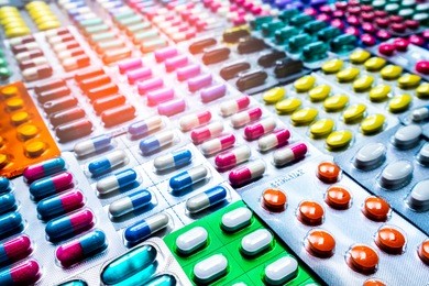 colorful of tablets and capsules pill in blister packaging arranged with beautiful pattern with flare light. pharmaceutical industry concept. pharmacy drugstore. antibiotic drug resistance.