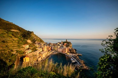 vernazza fisherman village at sunset. vernazza is one of five famous colorful villages of cinque terre in italy, suspended between sea and land on sheer cliffs. liguria, italy