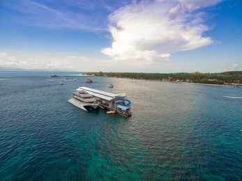 april 26 2018 bali indonesia : quicksilver boats taking tourists on lembongan to nusa penida, snorkeling diving, banana boat, water sport, parasailing, jet sky, fly fish, trips full day cruis bali