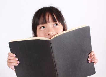 portrait of young happy girl with book