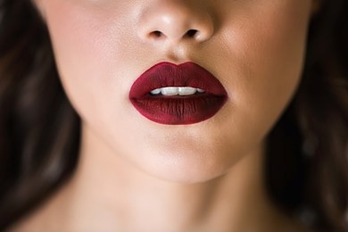 sensual red woman lips. half open lips. close up face of a woman with clean skin. the concept of cosmetics, care, beauty, fashion.
