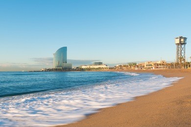 barceloneta beach in barcelona with colorful sky at sunrise. seafront, beach,coast in spain. suburb of barcelona, catalonia