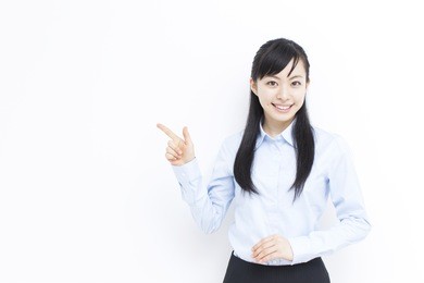 beautiful young business woman pointing copy space