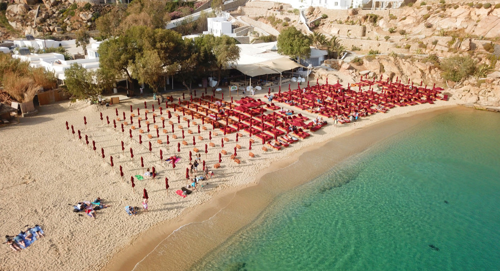 aerial drone, bird's eye view photo of iconic and famous beach of super paradise with sapphire clear waters, mykonos island, cyclades, greece
