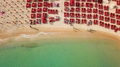 aerial drone, bird's eye view photo of iconic and famous beach of super paradise with sapphire clear waters, mykonos island, cyclades, greece