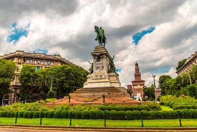 giuseppe garibaldi monument and tower of sforza castle - castello sforzesco in milan, italy