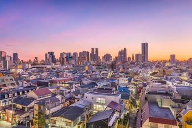 west shinjuku, tokyo, japan financial district cityscape over residential neighborhoods at dusk.