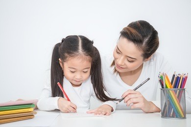 portrait of mother and daughter learning to write, mother teaching little girl homework how to write, education study home school mother's day concept 