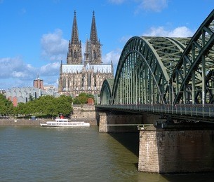 view on cologne cathedral and hohenzollern bridge over the rhine river, germany