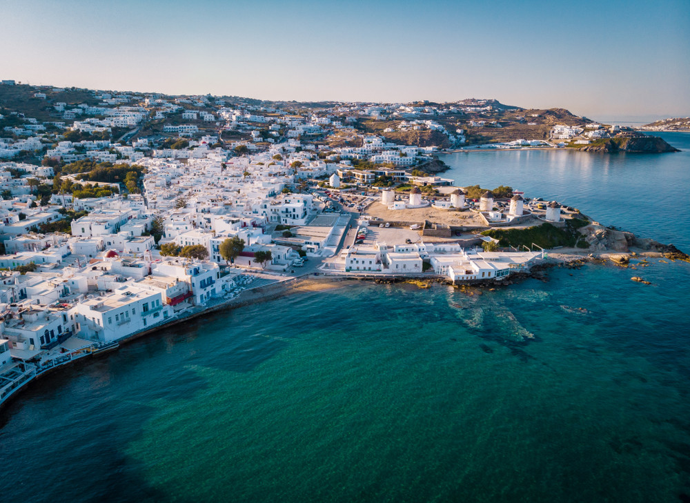 drone shot famous mykonos town windmills in a romantic sunset, mykonos island, cyclades, greece, drone panorama