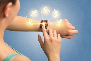 female hand with smartwatch and sport concept.