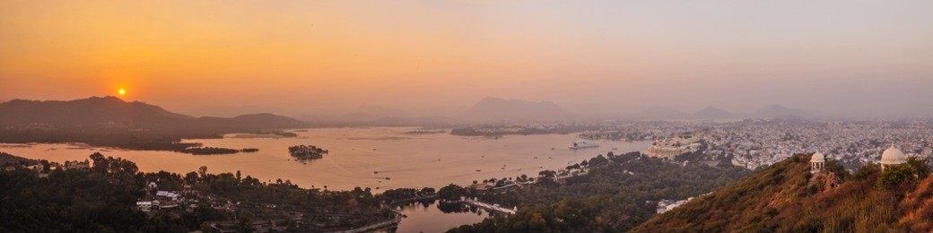 a panoramic image of udaipur and lake pichola, india