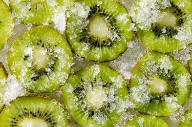 ice covered green sliced kiwi. closeup texture.
