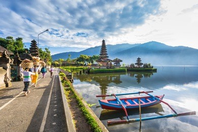 bali, indonesia-july 22, 2016: unidentified local people walk to pura ulun danu bratan, famous hindu temple on bratan lake in bali, indonesia. 