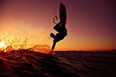 kite surfing at sunset.