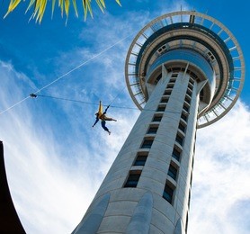 auckland sky tower from below with blue sky and someone jumping off