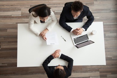 hr managers interviewing female job applicant, recruiters listen to candidate answering questions at hiring negotiations, recruiting and staffing, making first impression concept, top view from above